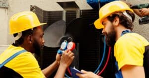 HVAC Technicians performing maintenance on AC unit